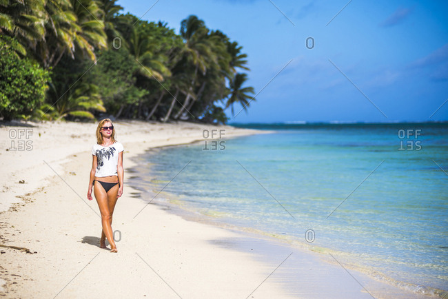 Woman Walking Along A Tropical Beach Rarotonga Island Cook Islands