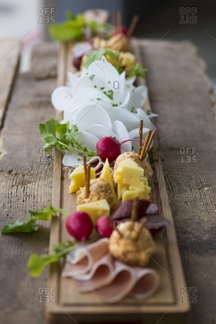 A supper board with cheese, obatzda (Bavarian cheese spread), radishes and ham at Oktober Fest