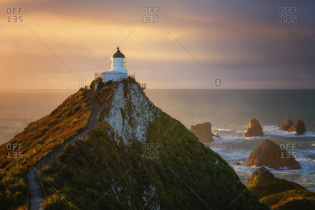 Nugget Point Lighthouse at sunrise, Nugget Point, Otago, South Island, New Zealand, Pacific