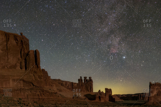 Moonlight on the Courthouse Towers with the Milky Way above the Three Gossips rock formation.