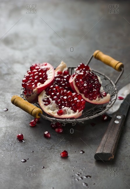 Pomegranate quarters in a wire basket