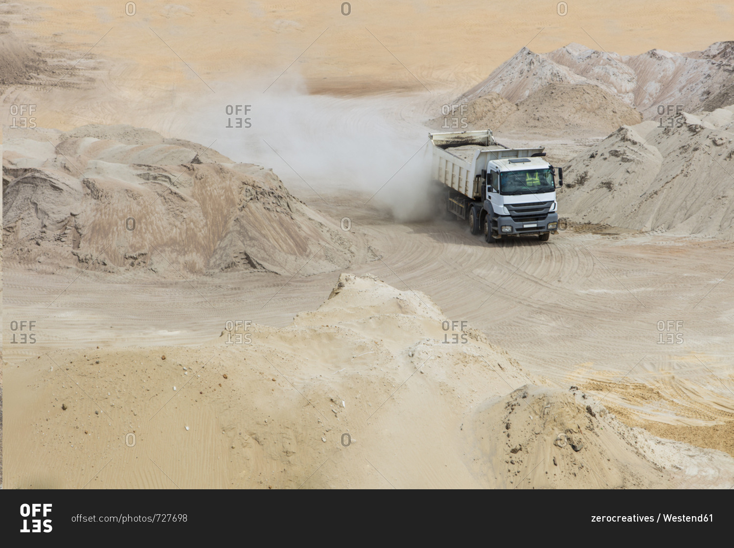Truck driving through sand heaps