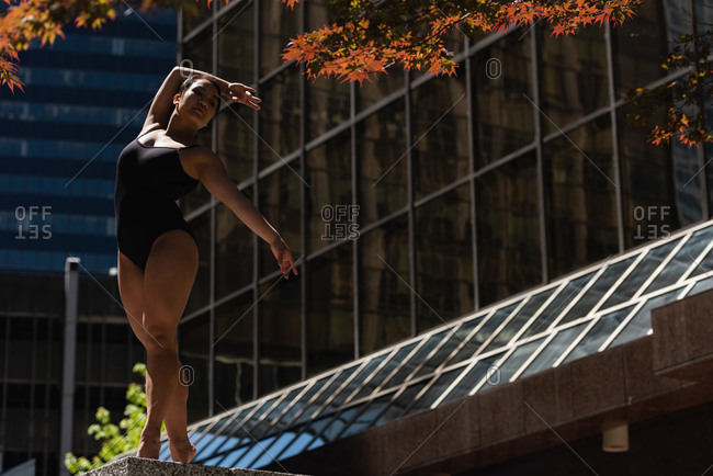 Beautiful female ballet dancer dancing in the city