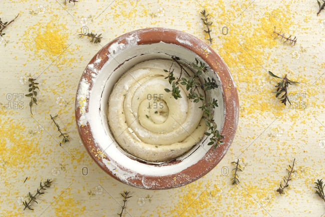 fresh dough in the flowerpot with spices and herbs