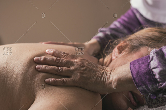 Therapist doing oriental massage with hands to woman to avoid muscle aches
