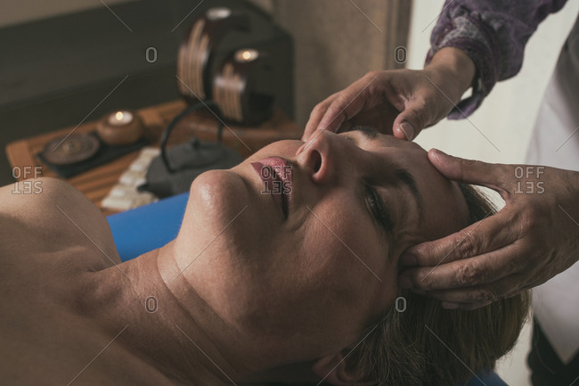 Therapist doing oriental massage with hands to woman to avoid muscle aches