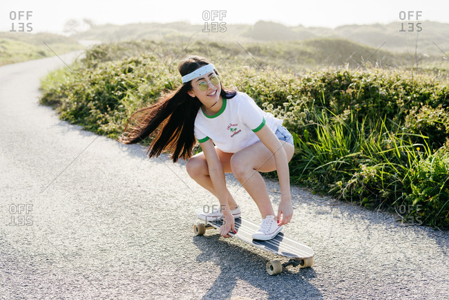 Brunette Girl Riding Penny Board