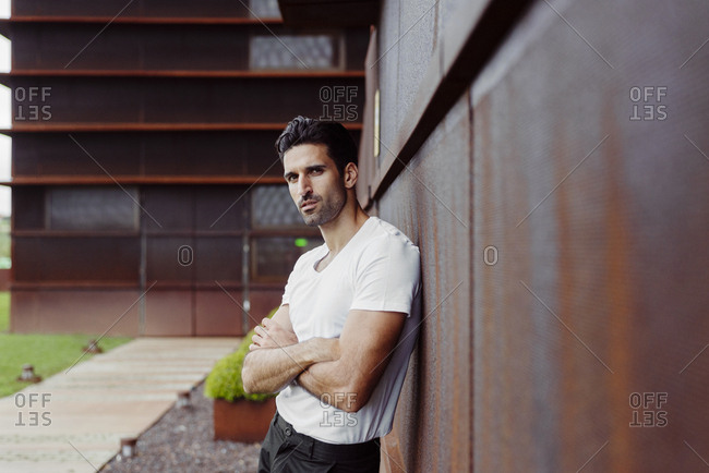 Fashion Portrait Of Young Man In White Shirt Poses Over Wall With Contrast  Shadows Stock Photo, Picture and Royalty Free Image. Image 17853431.