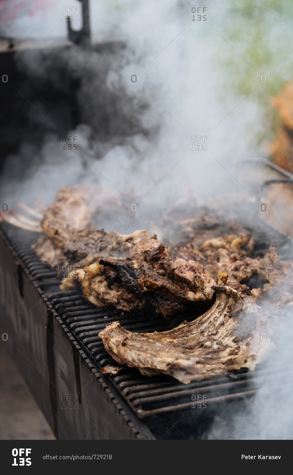 Smoking meat cooking on a grill