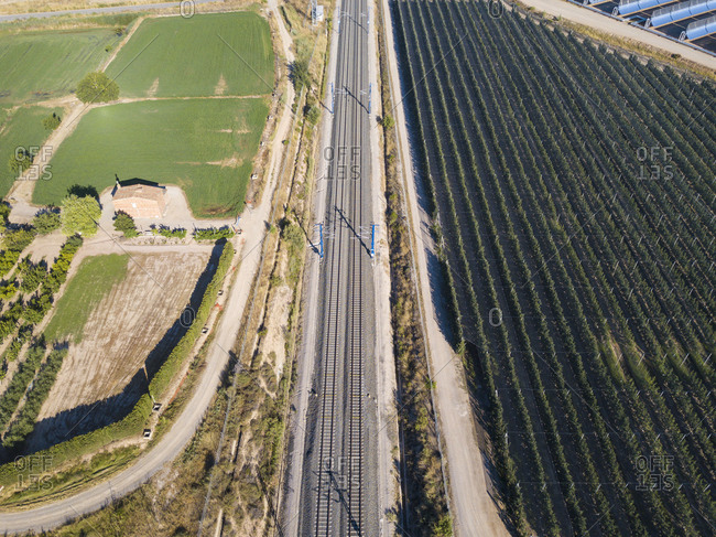 Aerial view of industrial infrastructure of railways, roads and agricultural fields in the autonomous community of Catalonia Spain