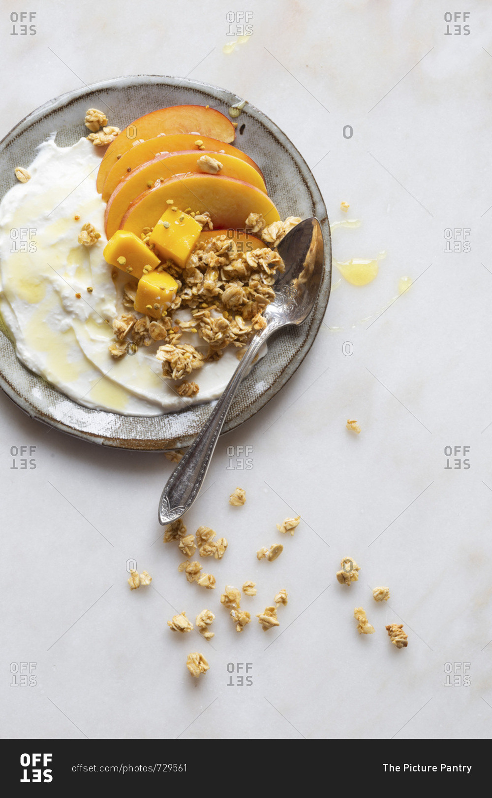 Gluten free breakfast to go - Greek yogurt, peach, mango and granola with honey and bee pollen.