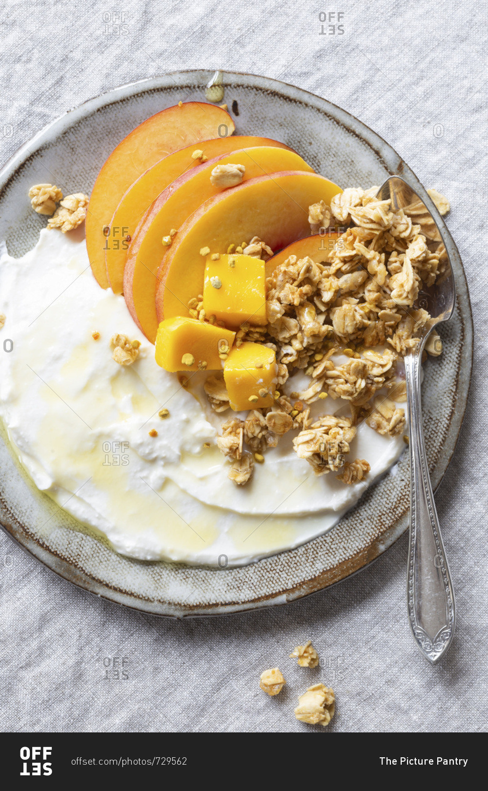 Gluten free breakfast to go - Greek yogurt, peach, mango and granola with honey and bee pollen.