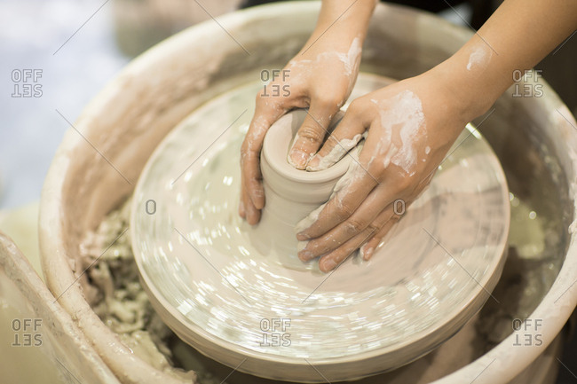 Close up of female potter's hands making pottery