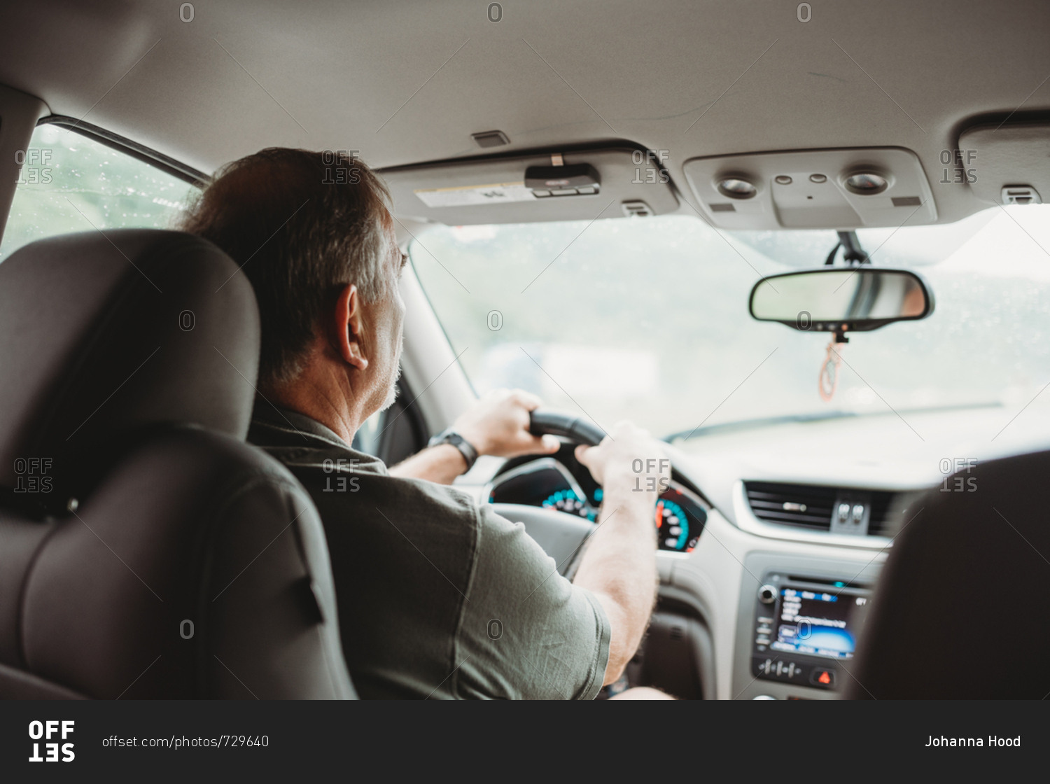 Back view of person driving a car stock photo OFFSET