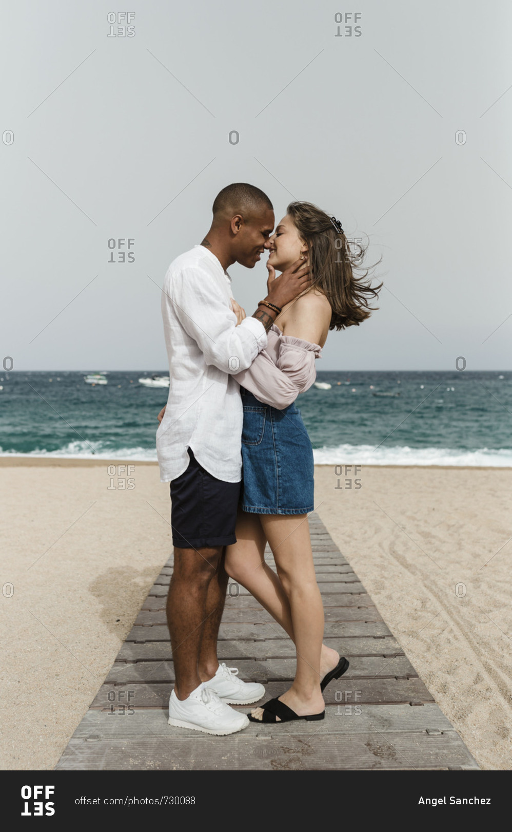 A young interracial couple in love at the beach