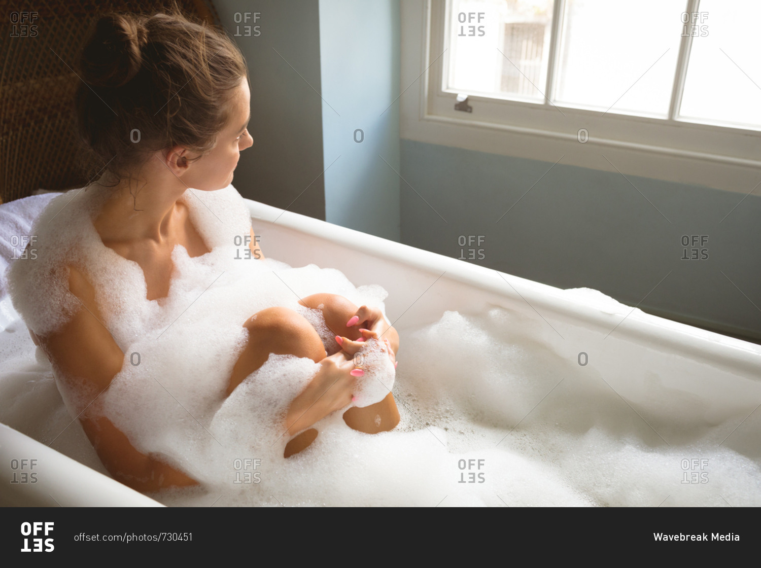 Woman taking a bath in bath tub at home stock photo OFFSET