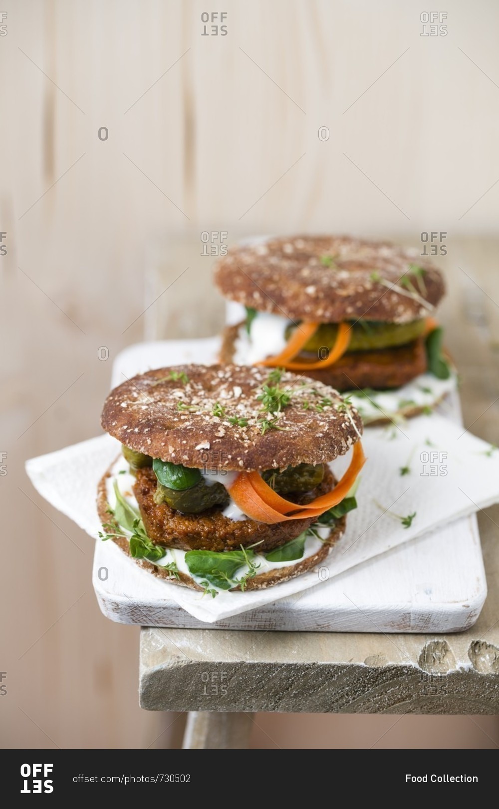 Vegan burger with tofu patty, gherkins, lamb\'s lettuce, carrot and cress
