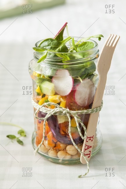 Complete meal vegetarian salad in a trendy lunch jar with disposable wooden fork tied on with bakers twine