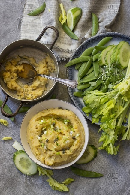 Yellow pea dip with cucumber, sugar snap peas, celery and pea leaves