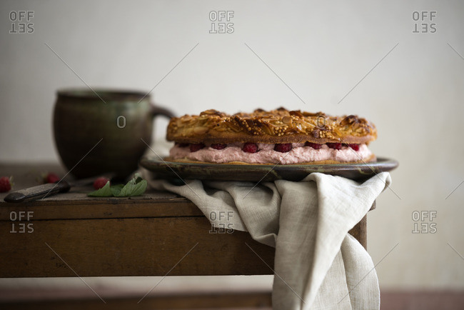 A vegan bee sting cake filled with raspberry cream and fresh berries