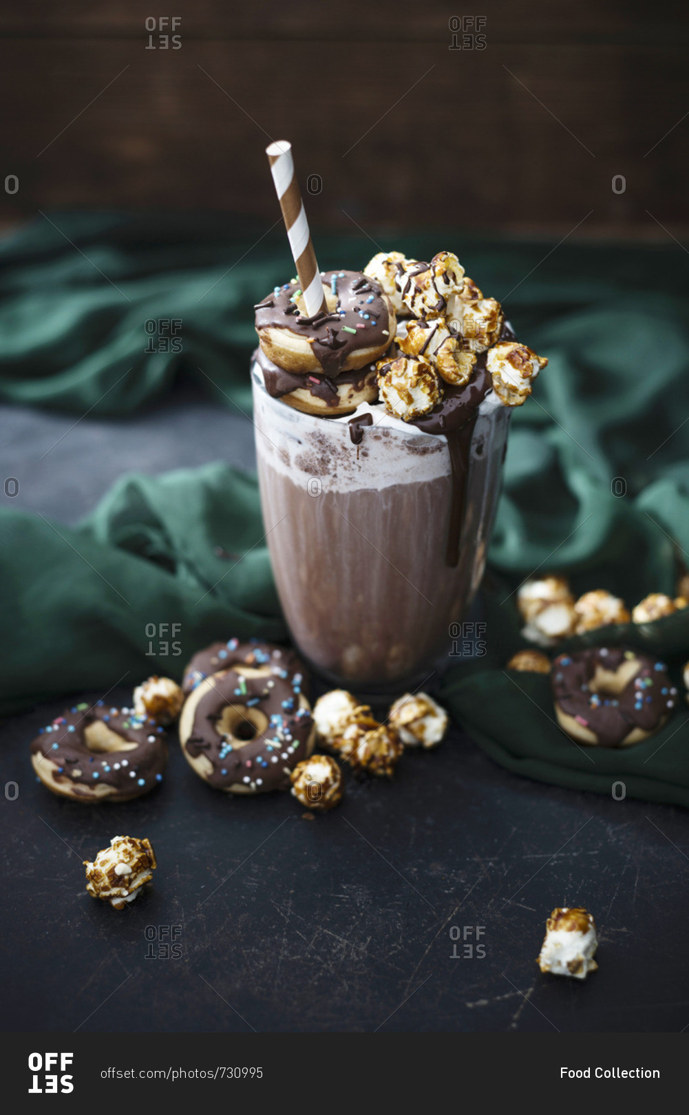 A chocolate and oat drink, soy cream, chocolate sauce, donuts and caramel popcorn (vegan)