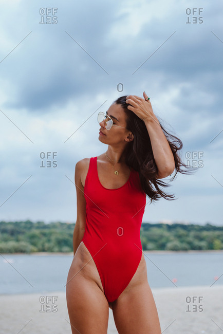 Woman in swimsuit poses with coctail, side view Stock Photo by NomadSoul1