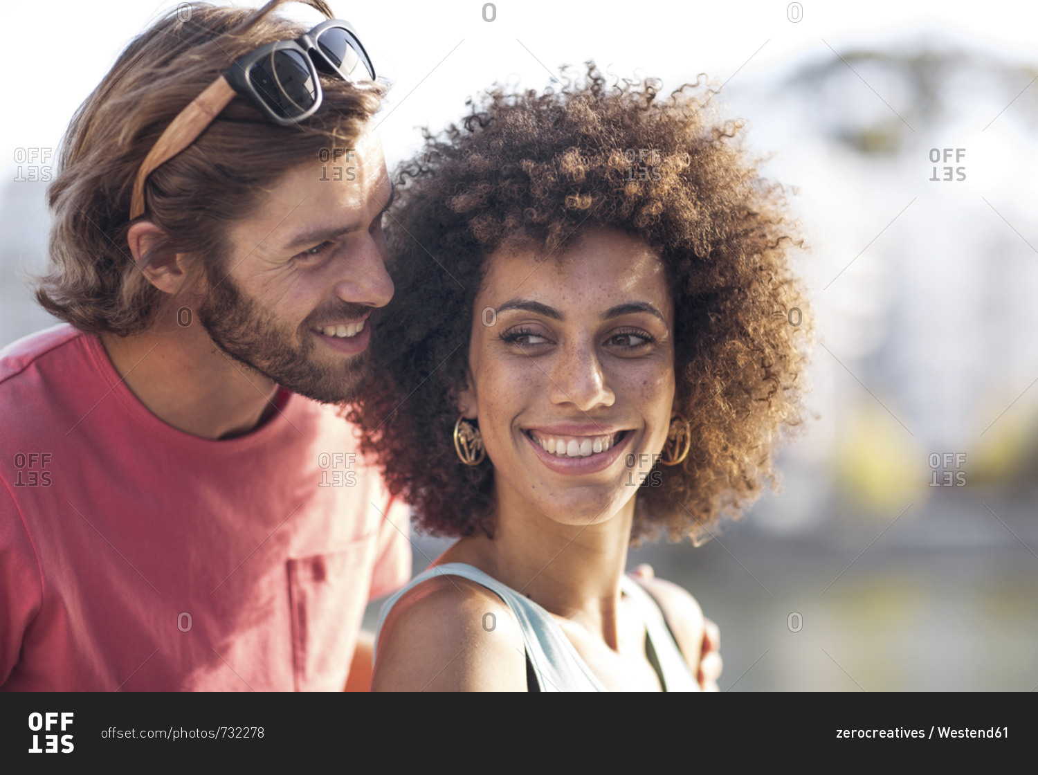 Happy young couple- man whispering into woman's ear