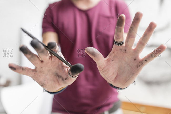 Artist showing his dirty hands
