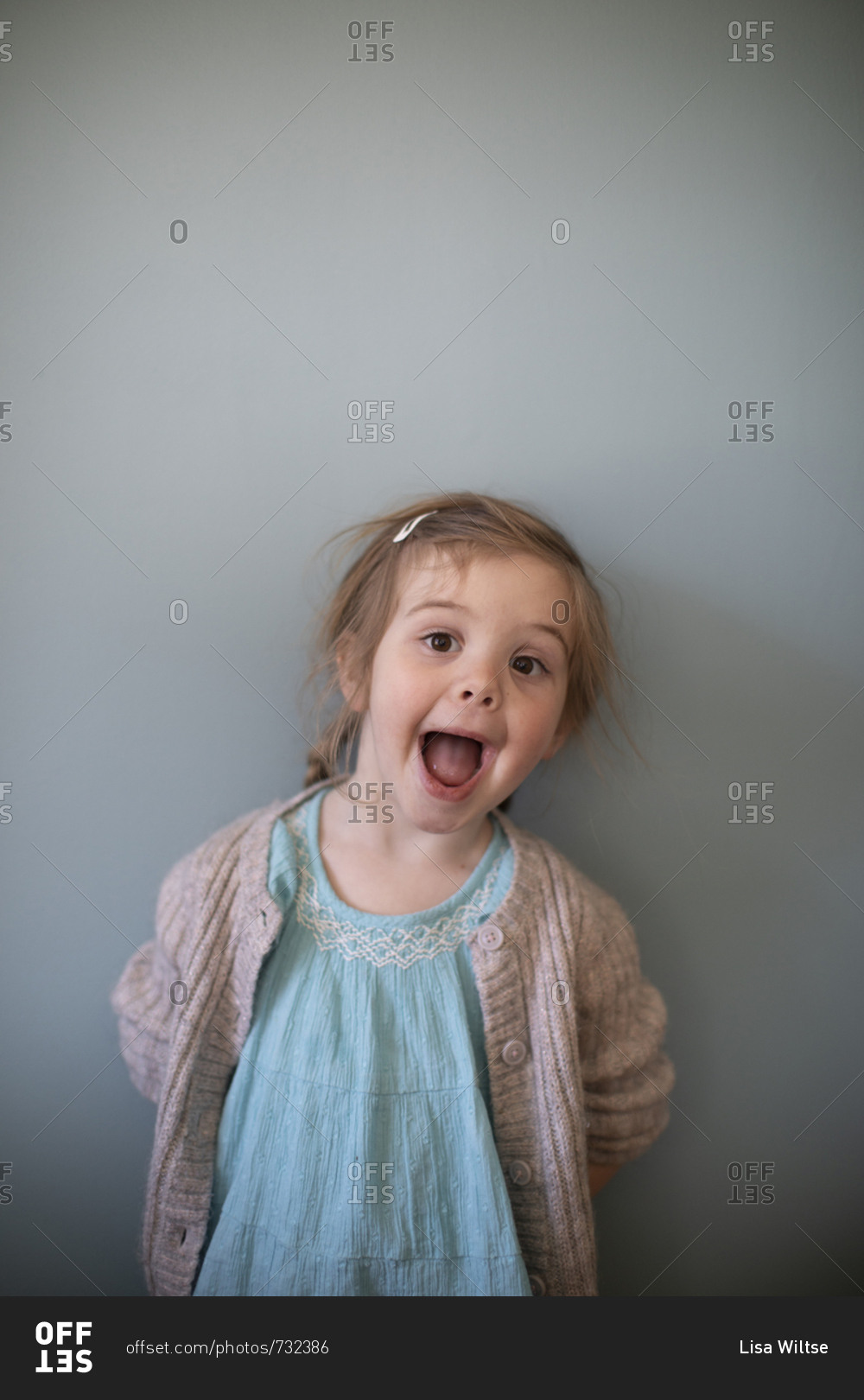 Portrait of a little girl making a silly face stock photo - OFFSET