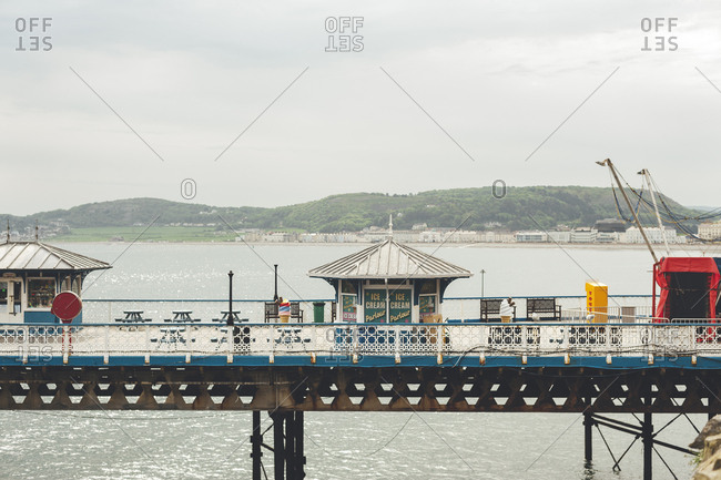 Llandudno, North Wales, UK - May 25, 2018: View of Llandudno Pier and city on background on a cloudy day