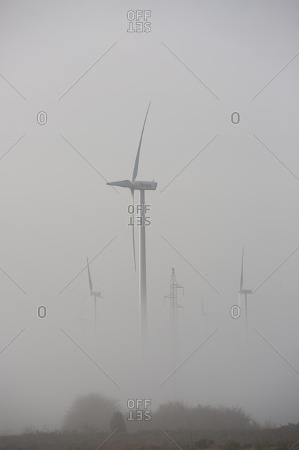 Wind turbines in fog, Burgos, Castile and Leon, Spain