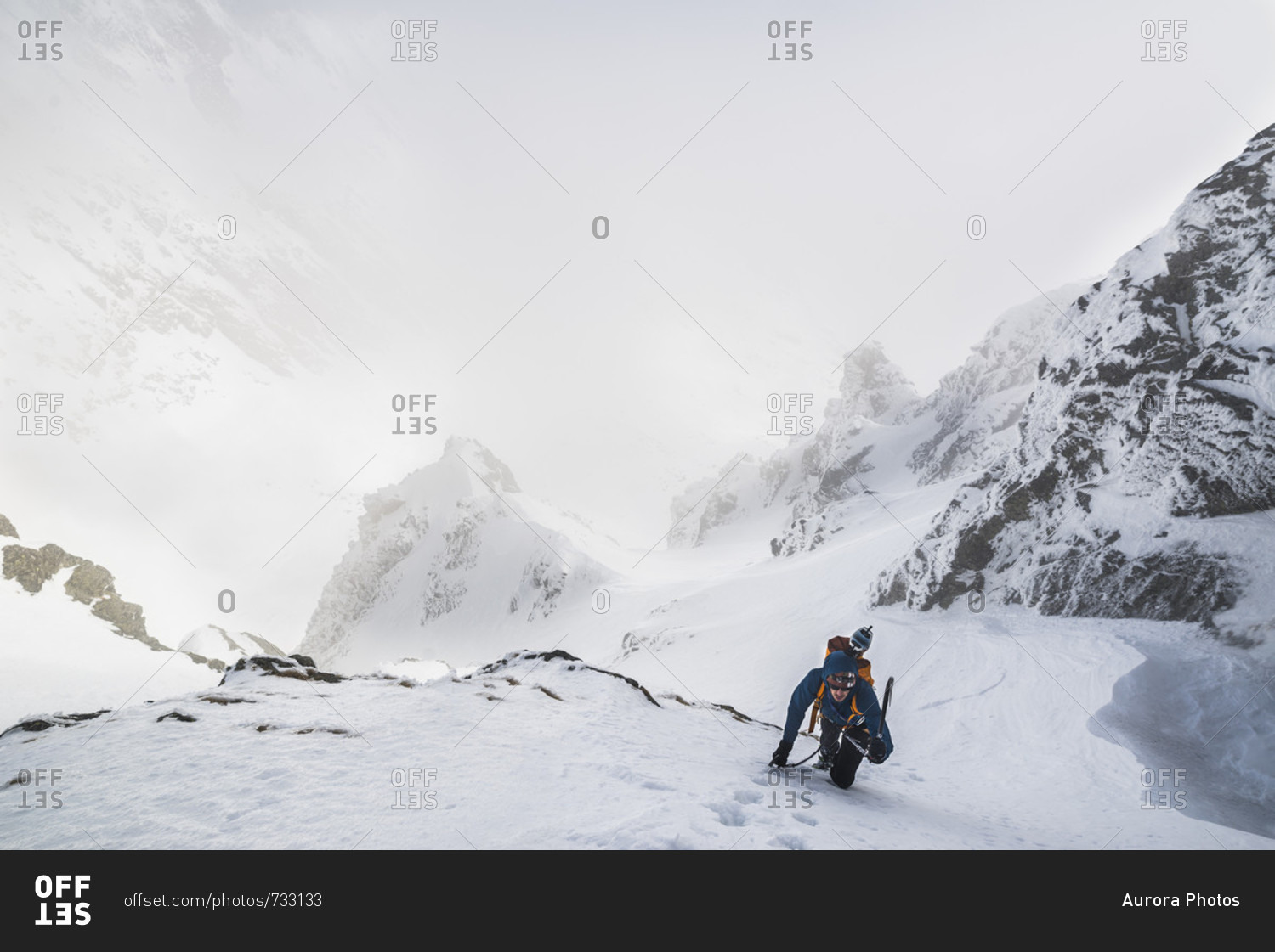 Mountain climber climbing up mountain in winter, Tatra Mountains, Slovakia