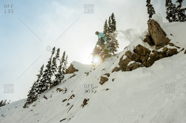 Extreme skier in mid-air after cliff jump, Crested Butte, Colorado, USA