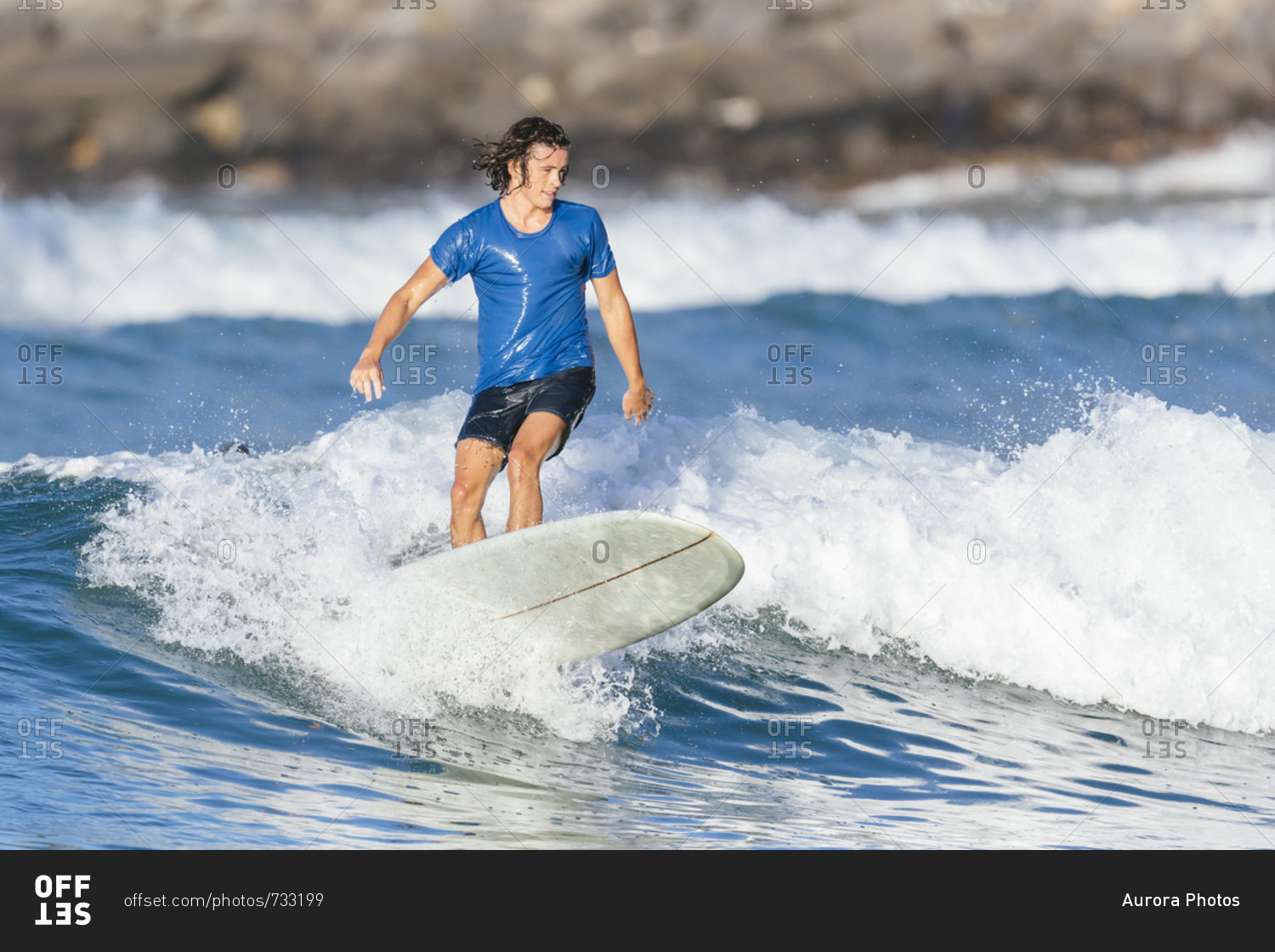 Young man surfing in sea