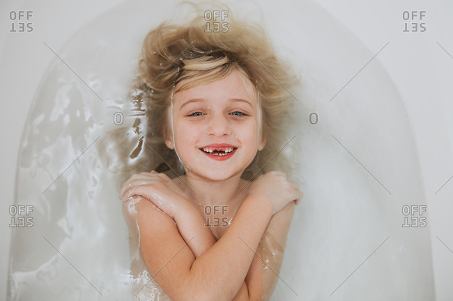 Little girl taking a bath stock photo - OFFSET