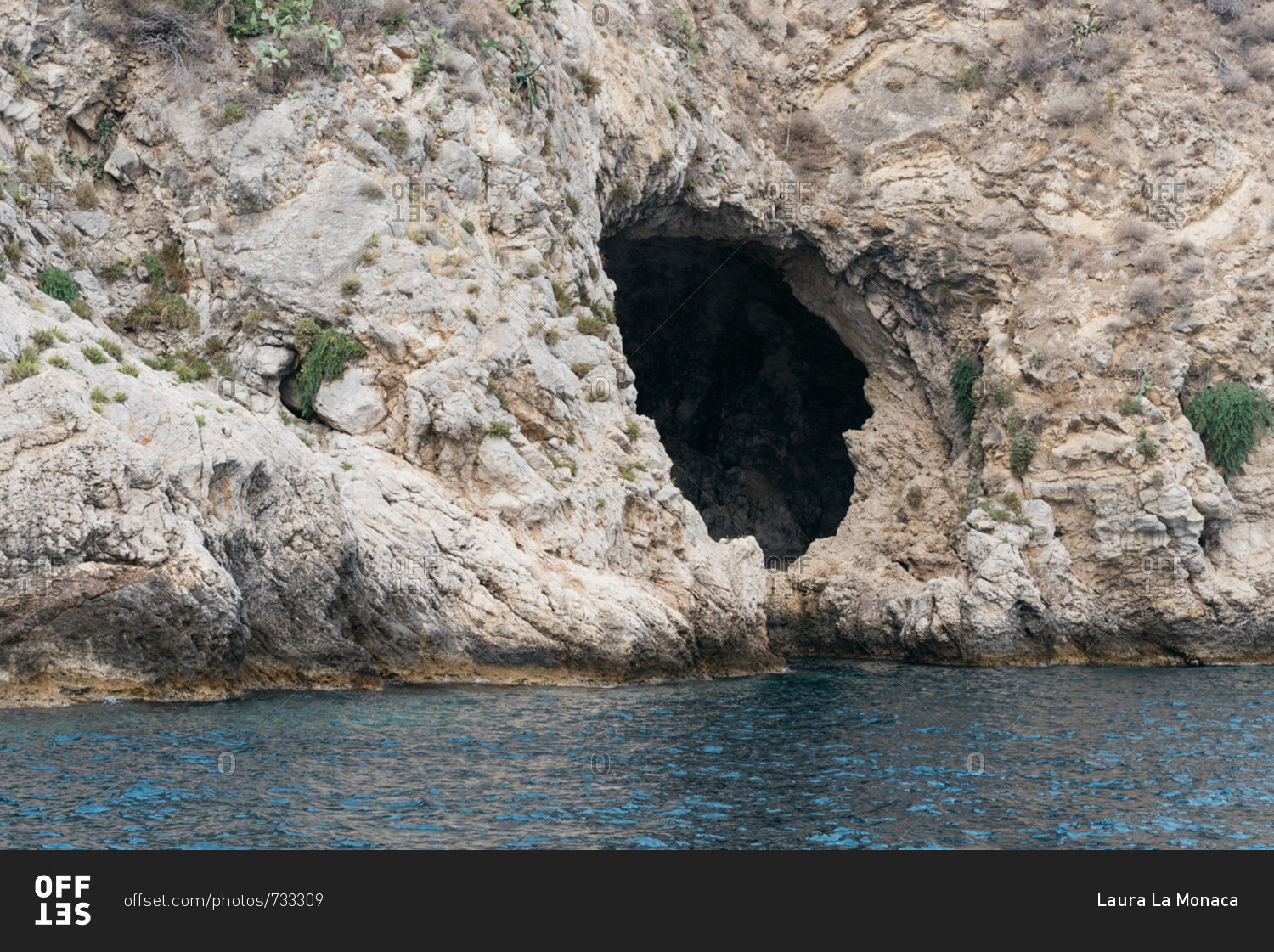 Cave on the coast of Giardini Naxos, Italy stock photo - OFFSET