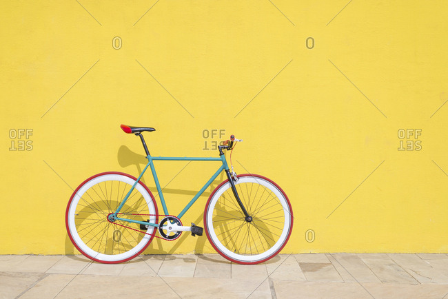 Vintage bike leaning on a yellow wall at Barcelona, Spain