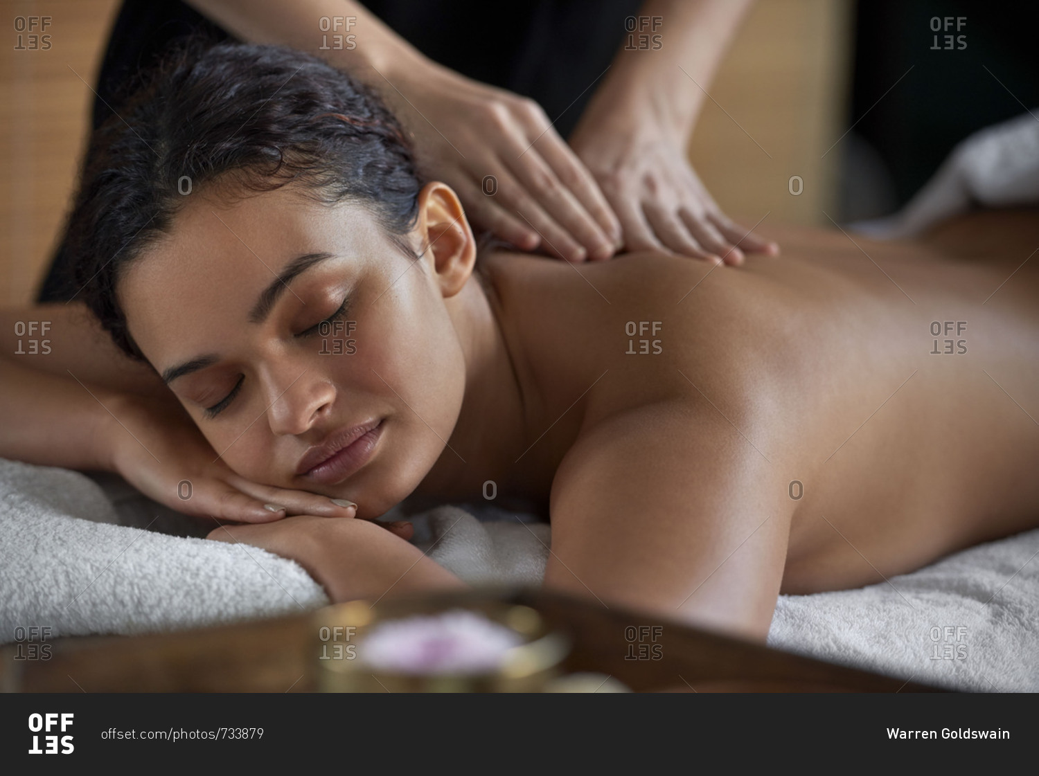 Young woman receiving a relaxing back rub at a spa