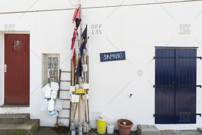 May 22, 2018: Buoys and fishing gear leaning on white wall, Port des Pecheurs, Biarritz, France