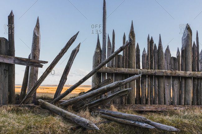 Old wooden fence with sharp tops on bluff overlooking expansive valley in Iceland