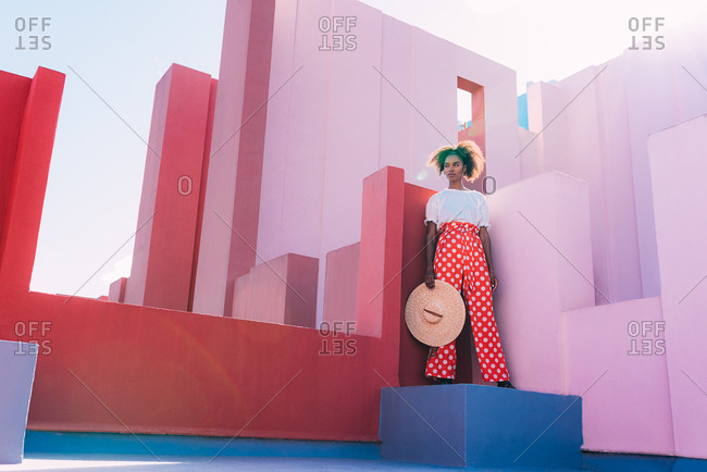 Black woman standing in a colorful geometric building roof terrace
