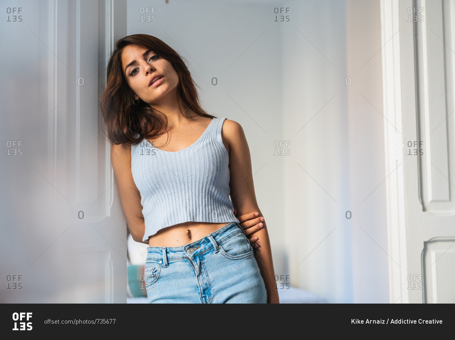 Slim beautiful woman standing at home stock photo - OFFSET