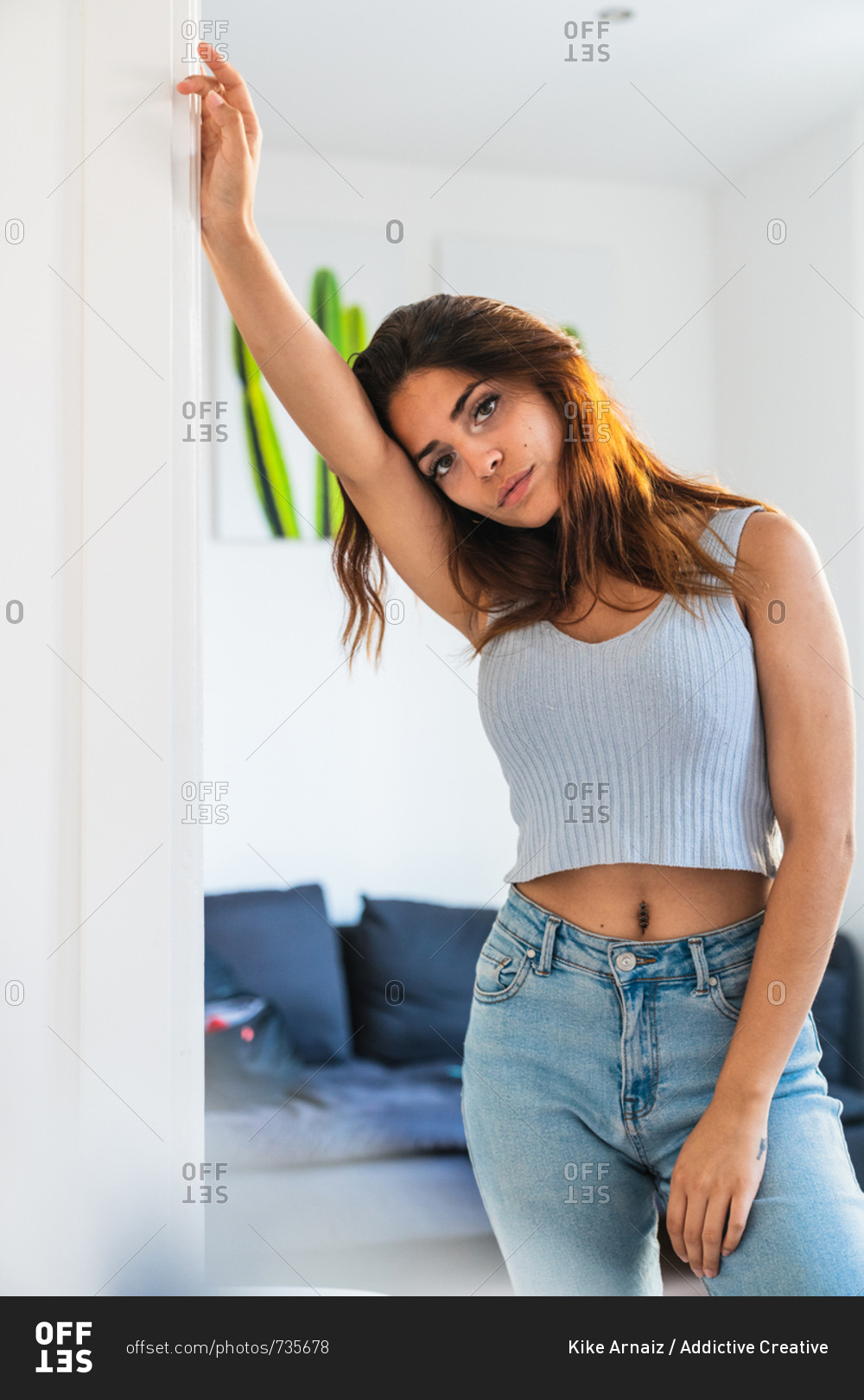 Slim beautiful woman standing at home stock photo - OFFSET