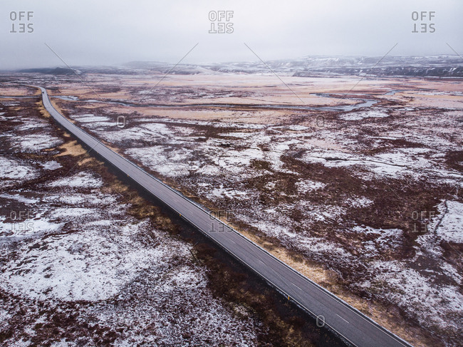 Road through snowy open space in Iceland