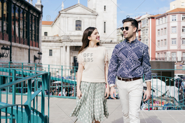 Stylish couple walking on street