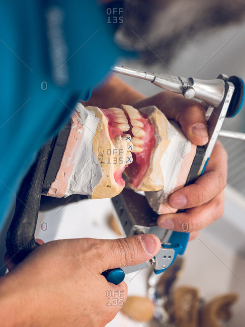 Dental technician making denture - Offset