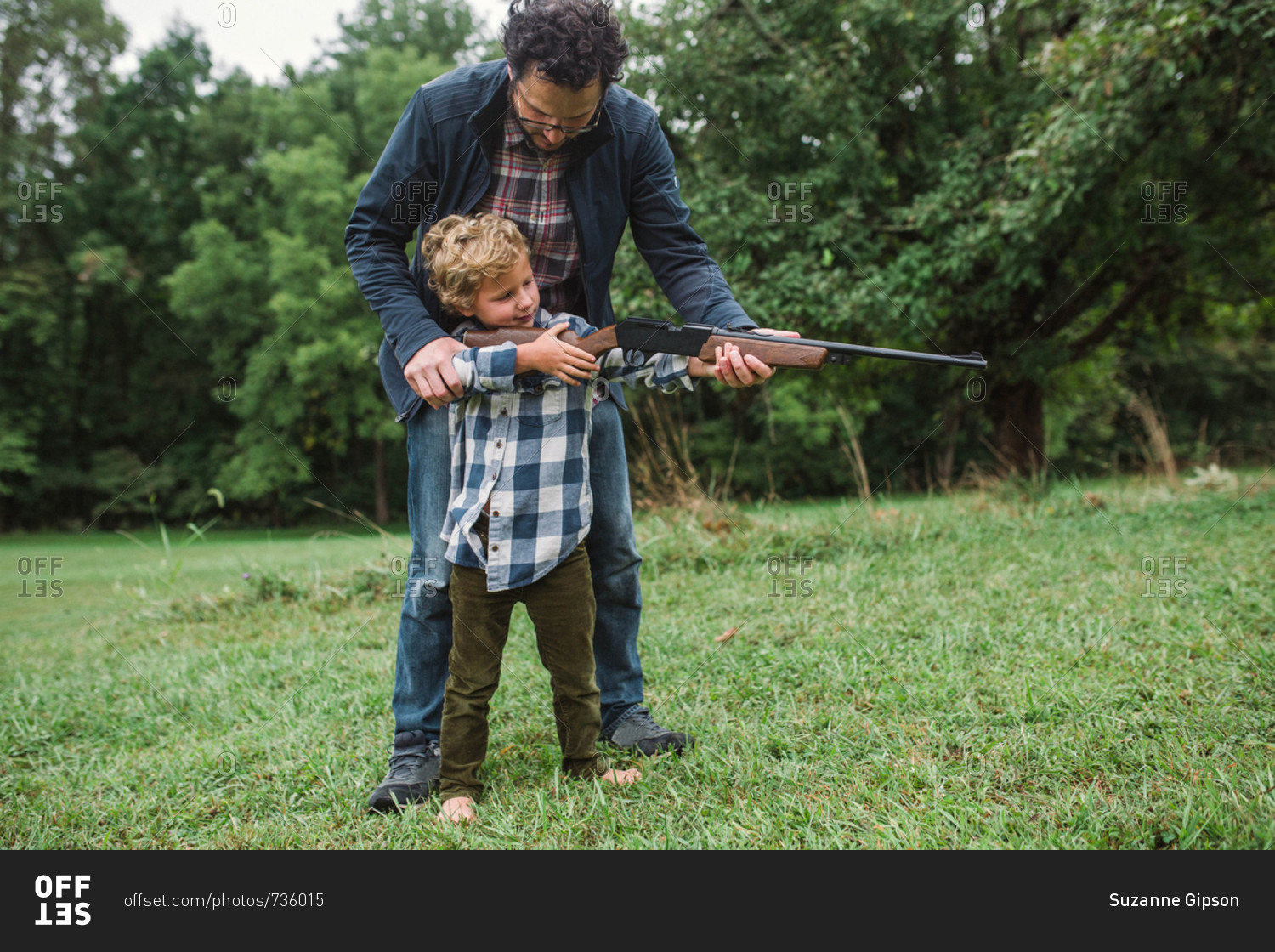 Father Teaching Son How To Shoot A Gun Stock Photo Offset