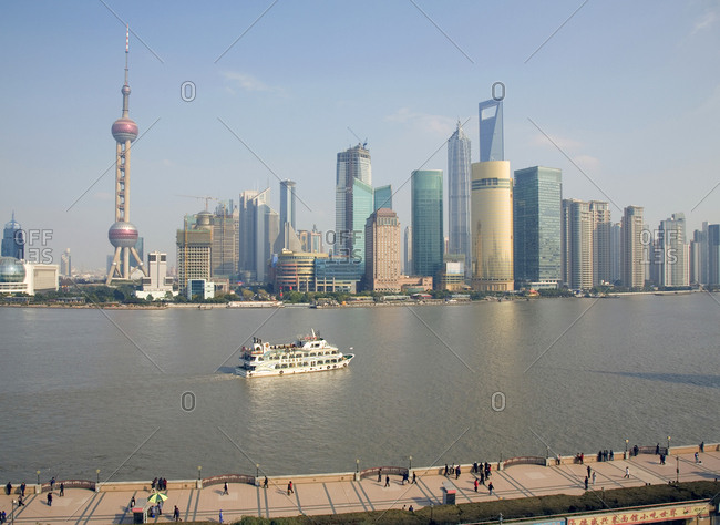 Shanghai, China - December 12, 2008: Pudong business district during daylight and the Huangpu River and tour boat