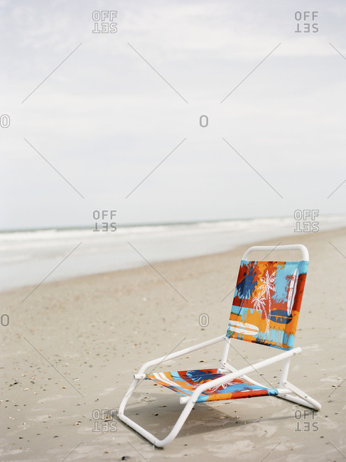 Empty chair on sandy beach