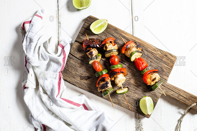 Grill skewers with grilled chicken- tomato- bell pepper and zucchini on chopping board